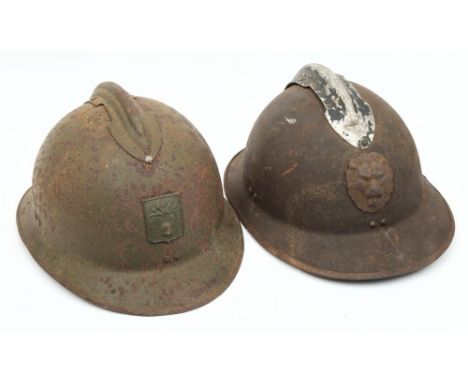 A WWII French Artillery M26 Adrian steel helmet: with attached comb and helmet plate, together with one other with lion's mas