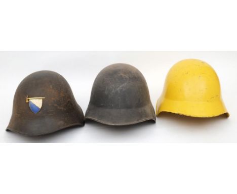 Three Swiss M1918/43 pattern steel helmets: one undecorated, one in yellow, the third with gilt and enamel Fire Service emble
