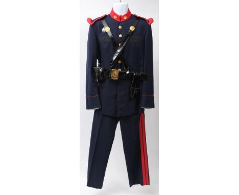 A Spanish Royal Guard uniform: comprising blue cloth tunic with red cloth collar and epaulettes, gilt buttons, black leather 