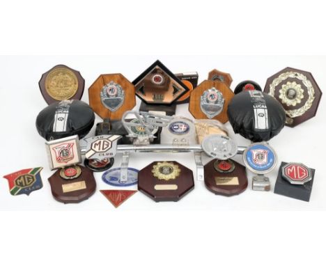 A collection of MG Car Club enamel radiator and bar badges: together with MG Car Club Rally Trophies and a badge bar with Luc