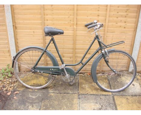 A mid 20th century BSA Shopper bicycle: green step through frame,chrome plated handlebars, bar rakes, three speed gears, fron