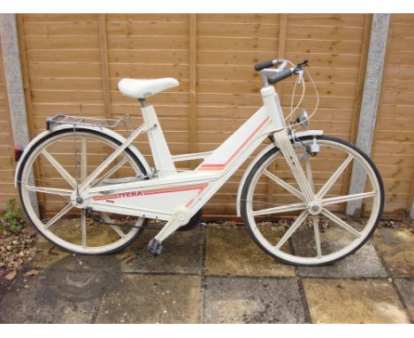 A 1980s Volvo designed Itera plastic  touring bicycle: the beige injection moulded step through frame with aluminium handle b