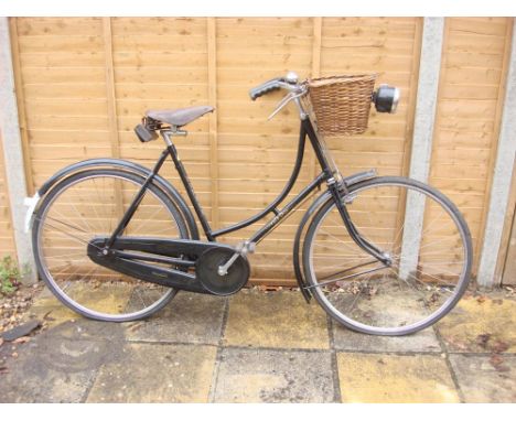 A 1930s Humber Sports lady's bicycle: black step through frame with gilt lettering, plated handlebars with bar brakes,  Brook