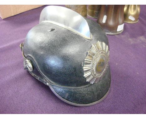 An early 20th century German black leather fire helmet by J R Lieb, Biberauh an der Riss: the skull with attached silver plat