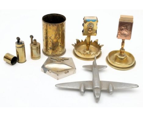Two WWI Trench Art smokers' companions: together with a shell case, two petrol lighters, a WWII alloy model of a twin engine 