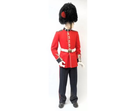 An ERII Coldstream Guards uniform: comprising bearskin, tunic and belt, trousers, gloves and boots on a mannequin.  