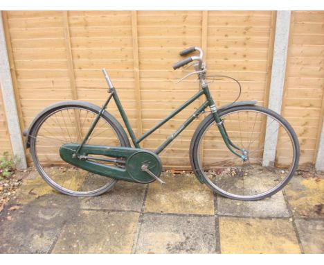 A Hercules 'Balmoral' lady's bicycle,: original green step through frame with decals,  chrome plated handle bars with solid b
