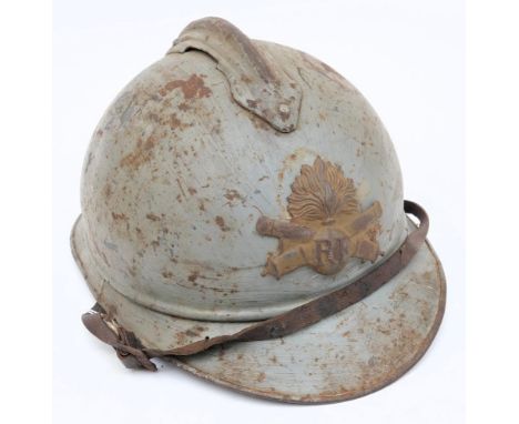 A WWI French Artillery Adrian pattern steel helmet: painted light blue with attached comb and  crossed cannon helmet plate, w