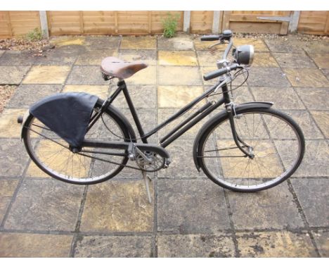 A Raleigh Sports lady's bicycle: all steel step through frame, black with gold lettering, Sturmey Archer three speed gears, J