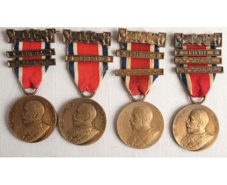 The King's Medal. A group of four Edward VII LCC Attendance medals with clasps to 'L ward' and W Harrison' in a display case,