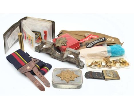 A collection of WWII button and shoulder badges: together with a Devonshire Regiment forge cap, a No64 MKI rifle scope (optic