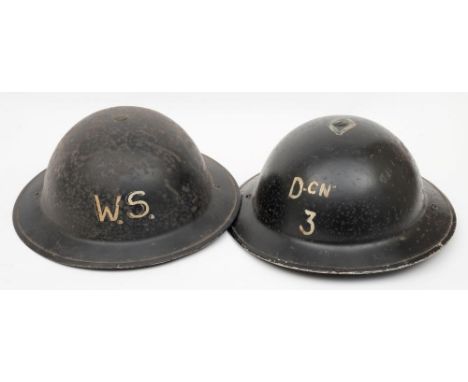 Two WWII Brodie pattern steel helmets: one inscribed 'DCN 3' with single diamond around crown button the other 'WS' (Warden S