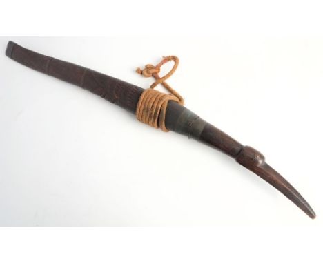 A 19th century Burmese Dha: the slightly curved blade  with copper bound hilt and bird's head carved wooden grip, the wooden 