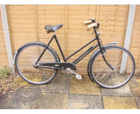 An early 20th century 'The Sun' bicycle: step through frame, black painted handlebars, bar brakes, single speed crank, chain 