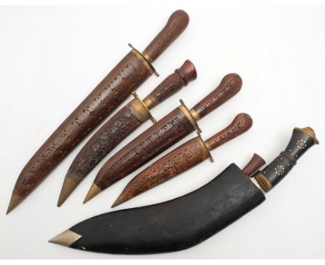 An ebony handled kukri in black leather scabbard,: together with four Indo-Persian knives with wooden grips and scabbards (5)
