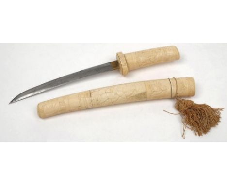 An early 20th century bone-handled Tanto: the short blade with landscape carved single piece grip in a three-section scabbard