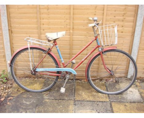 A BSA Bermuda lady's bicycle: red and blue step through frame, chrome plated handlebars with  three speed gears fitted wire b