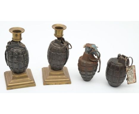 A pair of Mills hand grenade converted to candlestick: with brass sconces and raised on square bras plinths, 16cm high, toget