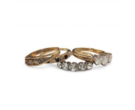 Three 9ct gold stone set rings and a 9ct gold on silver five stone paste set ring, all hallmarked Condition Report:9ct approx