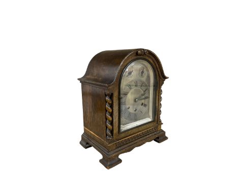 1930’s oak cased mantle clock with a three train chiming movement.