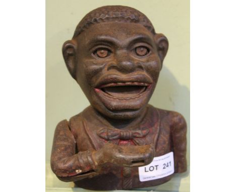 A cast metal money box These items are listed on the basis they are illustrative of a bygone culture in which there were diff
