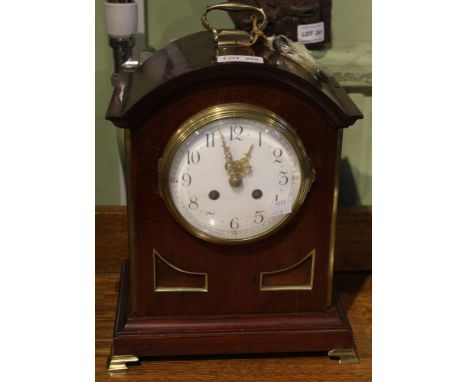 A Georgian design mahogany cased bracket clock, brass top handle and brass feet, white enamel dial with Arabic numbers, fitte