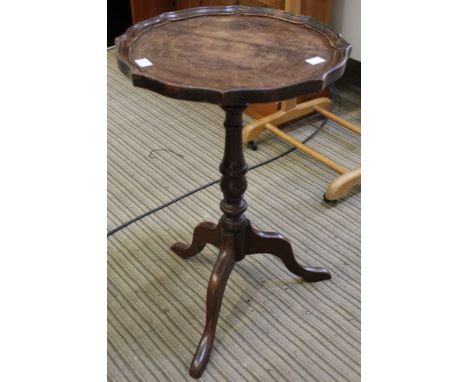 A dish topped tripod wine table