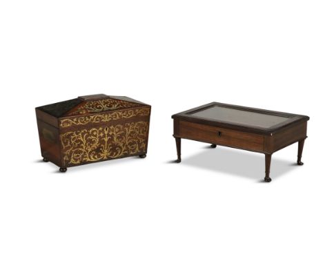 A REGENCY ROSEWOOD AND BRASS INLAID TEA CADDY, of sarcophagus form, with recessed brass side handles, 33cm wide; together wit