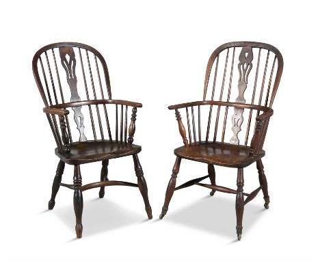 A PAIR OF PROVINCIAL ELMWOOD WINDSOR CHAIRS,the arched spindled back with pierced vase shaped splat, out-curved arms and soli