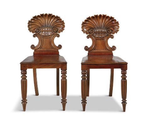A PAIR OF 19TH CENTURY MAHOGANY HALL CHAIRS, by Gillows of Lancaster, with carved scallop shell backs, panel seats, raised on