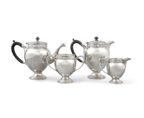 AN IRISH CELTIC REVIVAL FOUR PIECE TEA SERVICE, Dublin c.1916, mark of Edmond Johnson Ltd, comprising a teapot, hot water pot