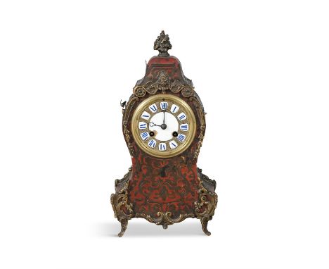 A FRENCH MANTEL CLOCK IN A RED BOULLE CASE, c.1900, with gilt metal mounts. 32cm high