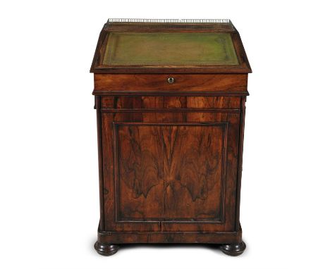 AN EARLY 19TH CENTURY ROSEWOOD DAVENPORT, with brass galleries and sliding slopefront section with fitted interior, the side 