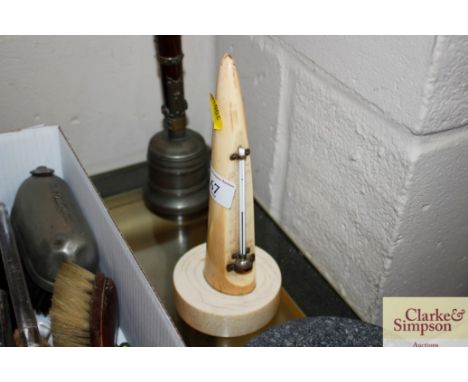 An antique ivory thermometer