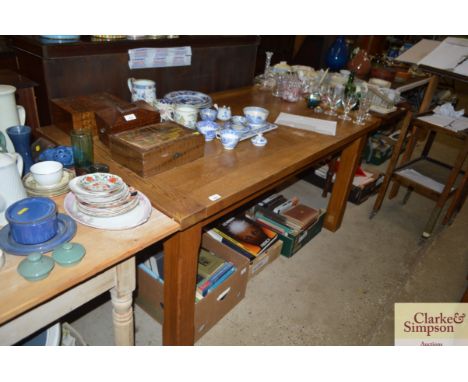 An oak dining table with a set of four matching ladder back chairs and two faux leather upholstered chairs