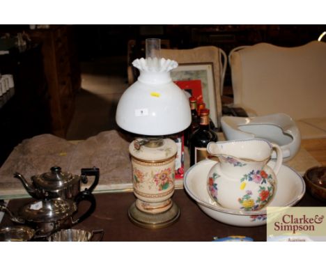 A Victorian pottery brass mounted oil lamp with opaque glass shade