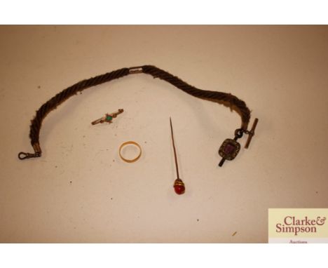 A box containing a yellow metal stick pin decorated with a serpent; a 22ct gold ring approx. 2.5gms; a yellow metal bar brooc