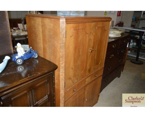 A walnut Art Deco design drinks cabinet, having maple lined interior