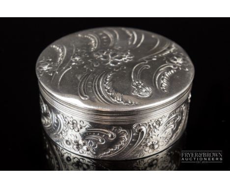 A sterling silver Tiffany &amp; Co. circular trinket box with removable and lockable lid, c1900, chased decoration of flowers
