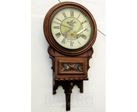 An American walnut wall clock, the circular metal dial painted with a swift and roses above a glass pendulum reveal panel, th