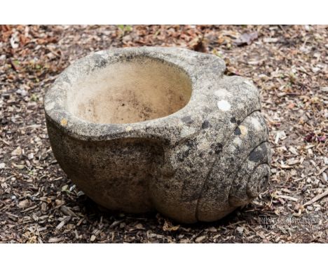 A stone planter in the form of a snail