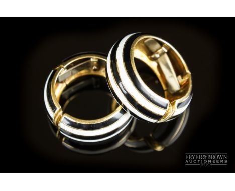 A stylish pair of 18ct gold and black &amp; white enamel hoop earclips, c1960, the hoops with champleve enamel and hinged cli