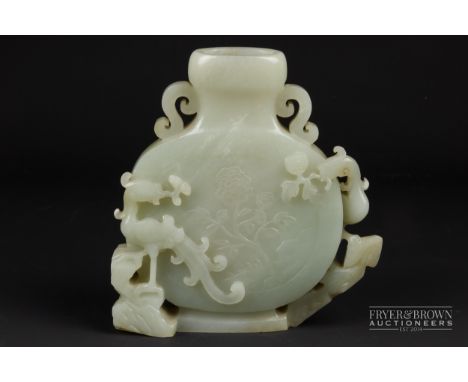 A Chinese pale celadon nephrite jade vase, of flattened globular form, carved in relief to one side with ho-ho or phoenix bir