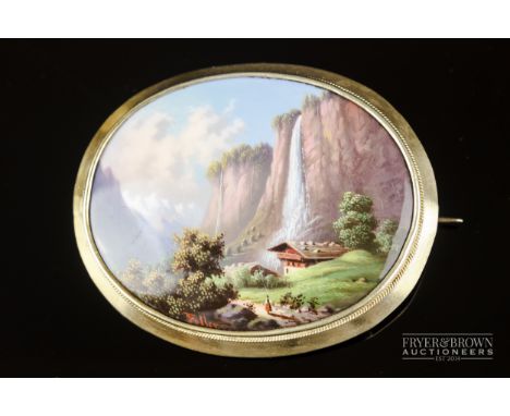 An antique Swiss enamel and gold brooch, c1860, the finely enamelled plaque depicting a mountainous landscape with waterfall,