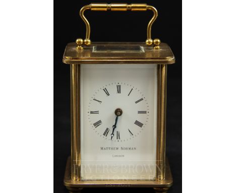 A Matthew Norman carriage clock, the white enamel face with Roman numerals, with key