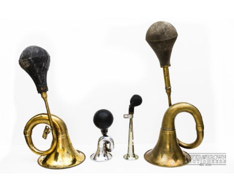 A large brass automobile horn with rubber bulb; another similar, smaller; and two small chromium examples (4)