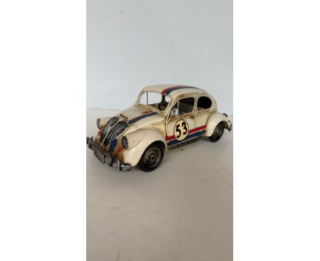 Vintage metal model car, inspired by the classic Volkswagen Beetle with racing livery. Hand-painted details, and open-frame d