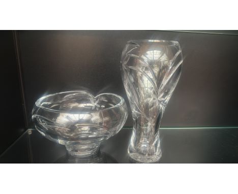 Cut crystal lot featuring a scalloped bowl and a tall flared vase, both with intricate floral etching.