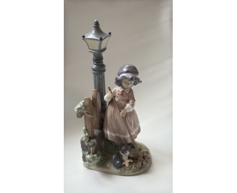 Lladro porcelain figurine #5286, "Spring Cleaning," designed in 1985. Features a young girl sweeping near a lamp post with a 