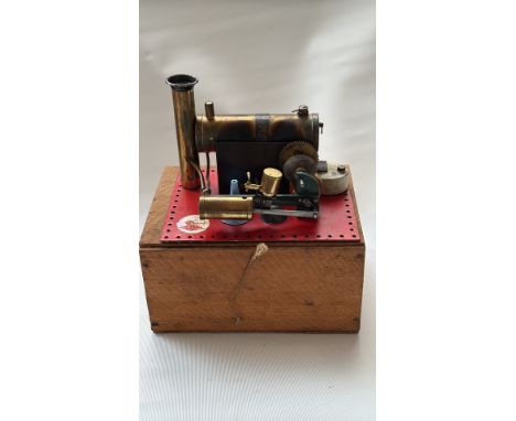 Vintage German Wilesco live steam engine model. Brass and metal construction mounted on a wooden base.
